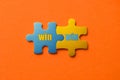 Two colored details of puzzle with text win win on orange background, Yellow and Blue, close up