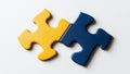 Two colored puzzle pieces, blue and yellow, are set against a white background Royalty Free Stock Photo