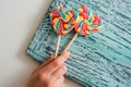 Two colored striped rainbow candy on a stick in the form of a heart. on a blue old vintage wooden background. The concept for Vale Royalty Free Stock Photo