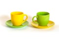 Two colored tea cups and saucers. Royalty Free Stock Photo