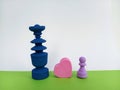 Two colorful Abstract chess pieces with a heart shape between them on a green and white background for the concept of love Royalty Free Stock Photo