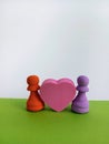 Two colorful Abstract chess pieces with a pink heart between them for the concept of love Royalty Free Stock Photo
