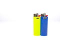 Two colorful Bic cigarette lighters isolated on white background. Royalty Free Stock Photo
