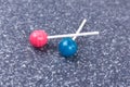 Two colorful candy suckers on sticks