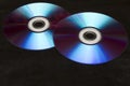 Two colorful CDs on a black background Royalty Free Stock Photo