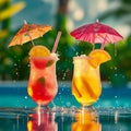 Two colorful cocktails by a sunny pool, one with a red umbrella garnish, evoking a relaxed, tropical vibe. Royalty Free Stock Photo