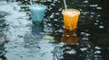 Two Colorful Disposable Cups Floating in a Puddle of Rainwater Royalty Free Stock Photo