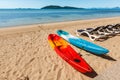 Two colorful empty canoe on the beach.