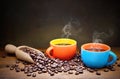 Two colorful espresso cups and coffee beans, space for text. Royalty Free Stock Photo