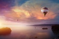 Two colorful hot air balloons flies in glowing sunset sky Royalty Free Stock Photo