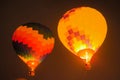 Two colorful hot air balloons flying with flames against dark sky Royalty Free Stock Photo