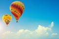 Two colorful hot air balloons up in the beautiful blue sky with Royalty Free Stock Photo