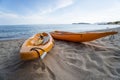 Two colorful orange kayaks on a sandy beach ready for paddlers in sunny day. Several orange recreational boats on the Royalty Free Stock Photo