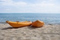 Two colorful orange kayaks on a sandy beach ready for paddlers in sunny day. Several orange recreational boats on the Royalty Free Stock Photo