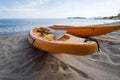 Two colorful orange kayaks on a sandy beach ready for paddlers in sunny day. Several orange recreational boats on the Royalty Free Stock Photo