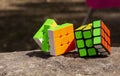 Two colorful rubik cube puzzle on the stone surface