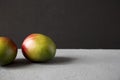 Two colorful sweet mangoes, side view. Space for text Royalty Free Stock Photo