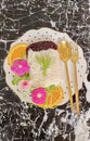 Two colors of rice decorated with flowers, orange slices and sunflower sprouts on a modern black background Royalty Free Stock Photo