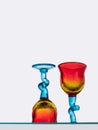 Two colourful glasses seen from low angle below.