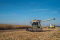 Two Combine harvesters in process of harvesting corn in the field Royalty Free Stock Photo