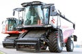 Two combines for harvesting grain. Large agricultural tractor on a white background.