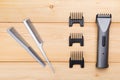 Two combs with attachments for electric cars, for hair cutting, on wooden boards Royalty Free Stock Photo