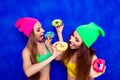 Two comic young women eating a delicious donut