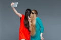 Two comical women with faces covered by hair taking selfie Royalty Free Stock Photo