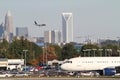 Two Commercial Jets with City Skyline Royalty Free Stock Photo