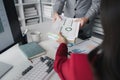 Two company employees handing over papers to each other, marketing staff handing over marketing analysis papers to department Royalty Free Stock Photo