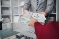 Two company employees handing over papers to each other, marketing staff handing over marketing analysis papers to department Royalty Free Stock Photo