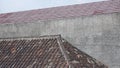 Two comparisons between Old clay roof behind the new metal tile roof