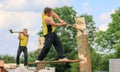 Two competitors chopping logs with an axe in the wood chopping event at a country show