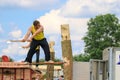 Two competitors chopping logs with an axe in the wood chopping event at a country show