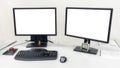 Two computer monitors are on the table in the office. On the monitors white screen to insert images or text