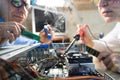 Two Computer Technicians repairing Hardware throw the window image Royalty Free Stock Photo