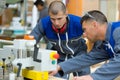 Two concentrated workers in factory