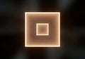 Two concentric squares emanates a warm, soft light against a dark Royalty Free Stock Photo