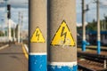 Two concrete electrical supports with symbols with high voltage warning, close up Royalty Free Stock Photo