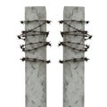Two Concrete Posts Wrapped in Barbed Wire Royalty Free Stock Photo
