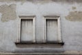 Two concreted windows on the facade of the old gray house Royalty Free Stock Photo