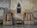 Two confessions boxes in catholic church of St. Sabina in Rome, Italy. Vintage interior and his pastel colors walls