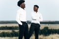 Two confident african american businessmen standing on top of a mountain, businessman success, winner leader concept Royalty Free Stock Photo