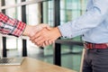 Two confident business man shaking hands during a meeting in the office, success, dealing, greeting and partner concept Royalty Free Stock Photo