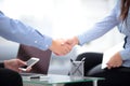 Two confident business man shaking hands during a meeting in office, success, dealing, greeting and partner concept.