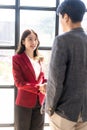 Two confident business men and women shaking hands during success meeting, Royalty Free Stock Photo