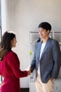 Two confident business men and women shaking hands during success meeting, Royalty Free Stock Photo