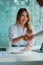 Two confident business people shaking hands during office meeting. Modern, greeting agreement concept. Royalty Free Stock Photo