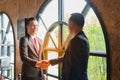 Two confident businessman shaking hands for demonstrating their agreement to sign agreement or contract between their firms Royalty Free Stock Photo