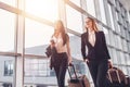 Two confident businesswomen carrying suitcases in airport Royalty Free Stock Photo